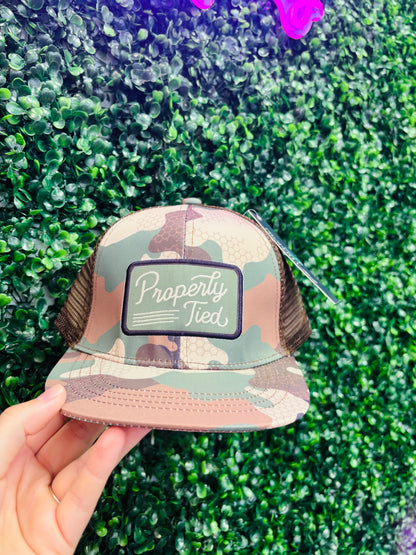 Boy sportsman Trucker hat properly tied
